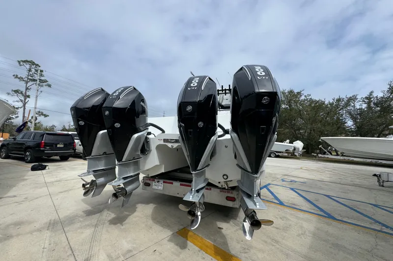 Slide: The Image of 2026 Invincible 36 Catamaran with four powerful outboard engines in a parking lot. - 13