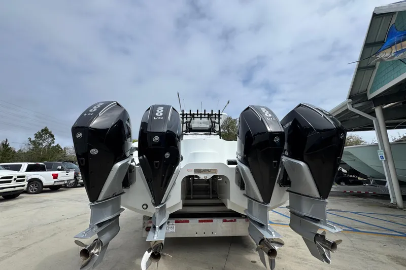 Slide: The Image of 2026 Invincible 36 Catamaran with four powerful outboard engines, parked outdoors. - 14