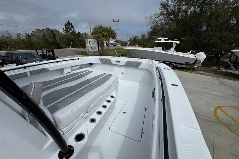 Slide: The Image of 2026 Invincible 36 Catamaran with spacious seating and sleek design, docked outdoors. - 17