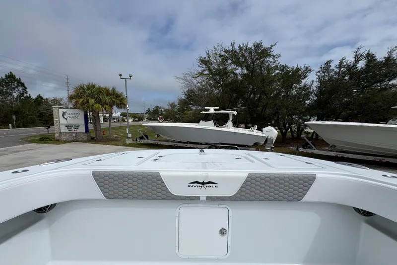 Slide: The Image of 2026 Invincible 36 Catamaran at a marina, surrounded by trees and other boats. - 18