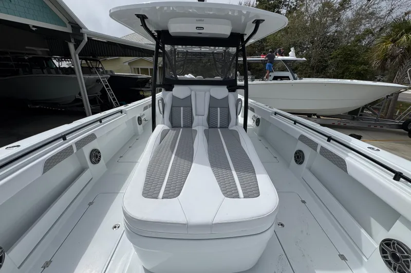 Slide: The Image of 2026 Invincible 36 Catamaran with sleek seating and modern design in a marina setting. - 22