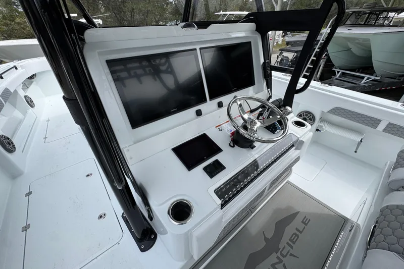 Slide: The Image of 2026 Invincible 36 Catamaran helm with dual screens and modern controls. - 31