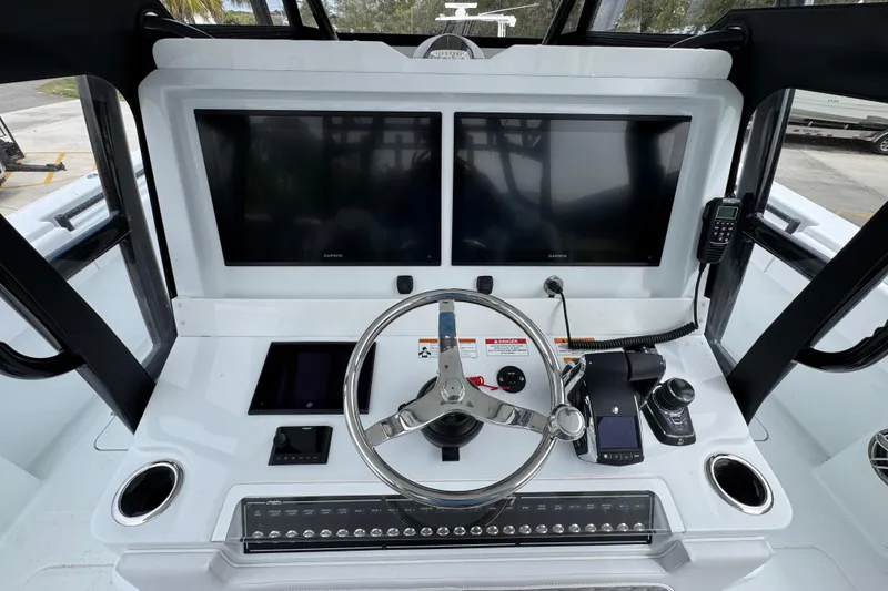 Slide: The Image of Helm of 2026 Invincible 36 Catamaran with dual screens and modern controls. - 32