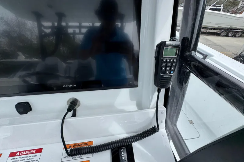 Slide: The Image of 2026 Invincible 36 Catamaran dashboard with Garmin display and Icom radio. - 34