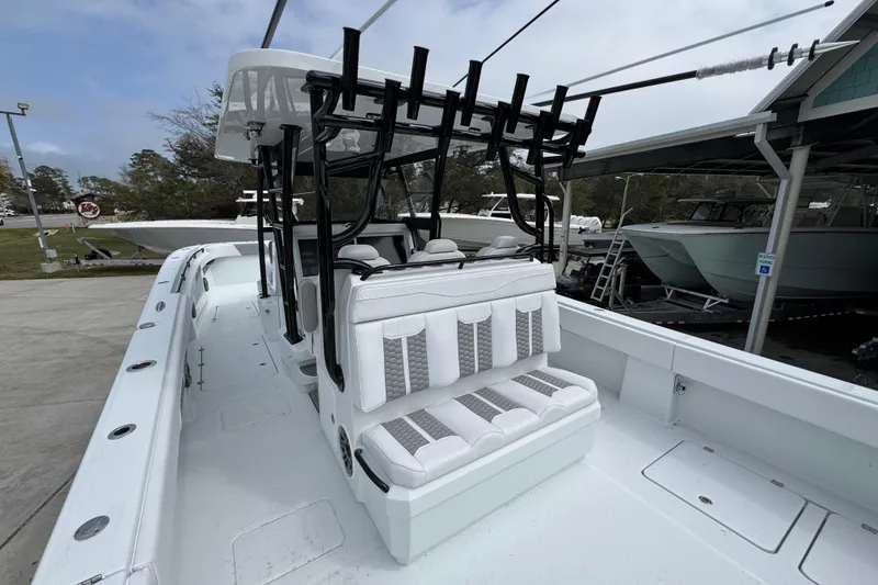 Slide: The Image of 2026 Invincible 36 Catamaran with sleek seating and fishing rod holders, docked outdoors. - 36