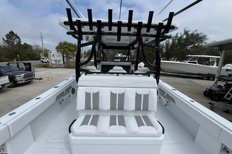 Slide: The Image of 2026 Invincible 36 Catamaran with white seating and rod holders, docked outdoors. - 37