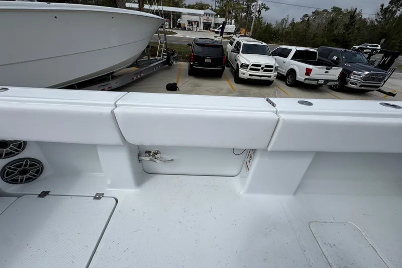 Slide: The Image of 2026 Invincible 36 Catamaran interior with speakers, parked cars in background. - 39