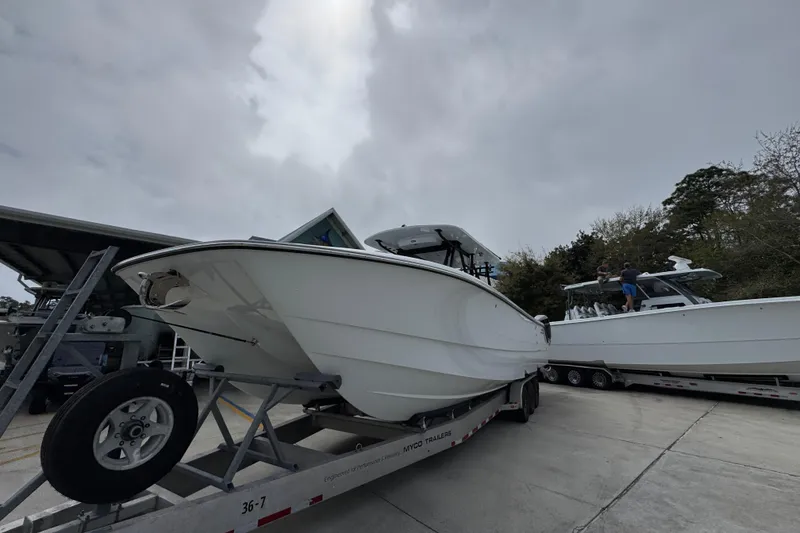 Slide: The Image of 2026 Invincible 36 Catamaran on trailer, overcast sky, parked outdoors. - 4