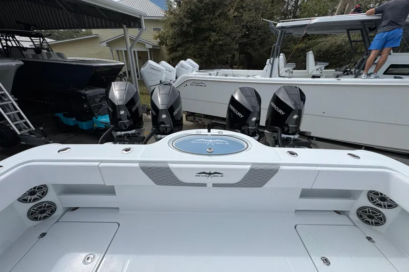 Slide: The Image of 2026 Invincible 36 Catamaran with four Mercury outboard engines, docked in a marina. - 41