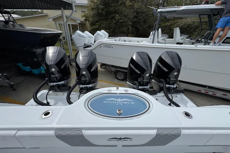 Slide: The Image of 2026 Invincible 36 Catamaran with four Mercury outboard engines in a marina setting. - 42