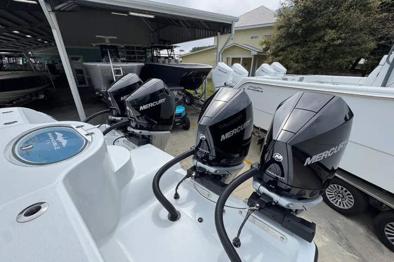 Slide: The Image of 2026 Invincible 36 Catamaran with four Mercury outboard engines in a marina setting. - 43