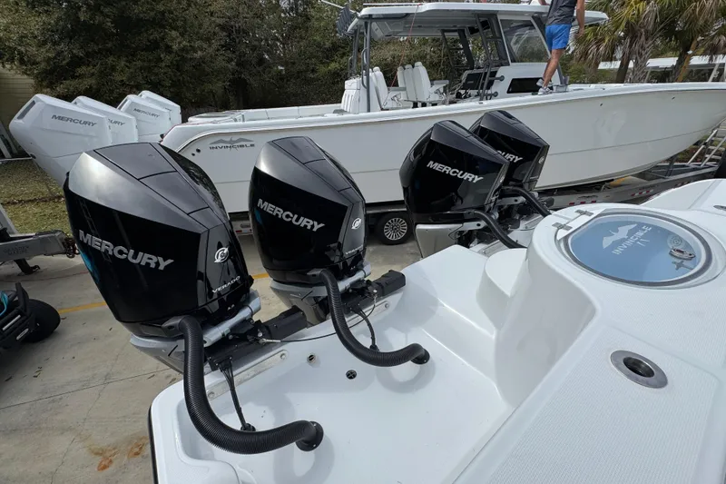 Slide: The Image of 2026 Invincible 36 Catamaran with Mercury outboard engines, docked and ready for adventure. - 44