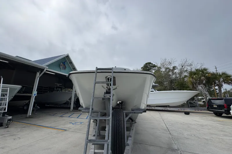 Slide: The Image of 2026 Invincible 36 Catamaran on trailer at marina, overcast sky. - 6