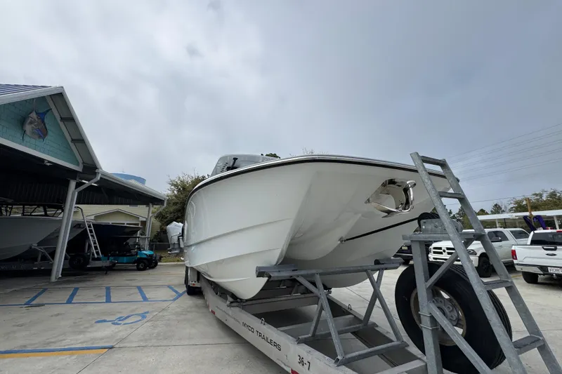 Slide: The Image of 2026 Invincible 36 Catamaran on trailer at marina, overcast sky. - 7