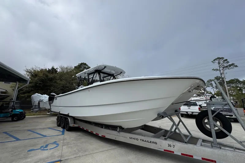 Slide: The Image of 2026 Invincible 36 Catamaran on trailer, parked outdoors under cloudy sky. - 8