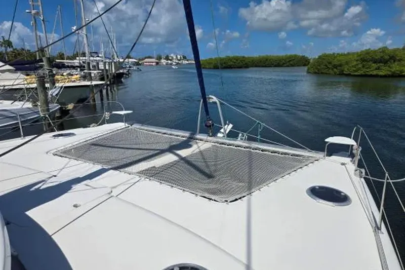 Slide: The Image of 2008 Fountaine Pajot Salina 48 Evolution catamaran docked in a serene marina. - 10