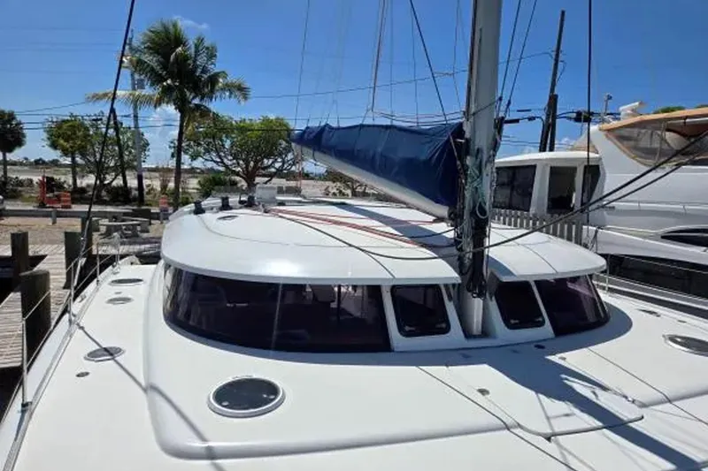 Slide: The Image of 2008 Fountaine Pajot Salina 48 Evolution catamaran docked under clear blue sky. - 11