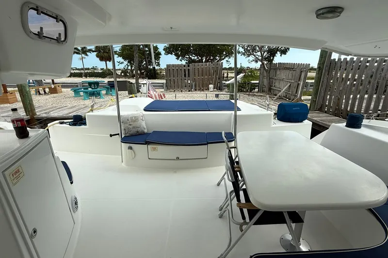 Slide: The Image of Outdoor seating area on 2008 Fountaine Pajot Salina 48 Evolution catamaran, featuring table and cushions. - 15