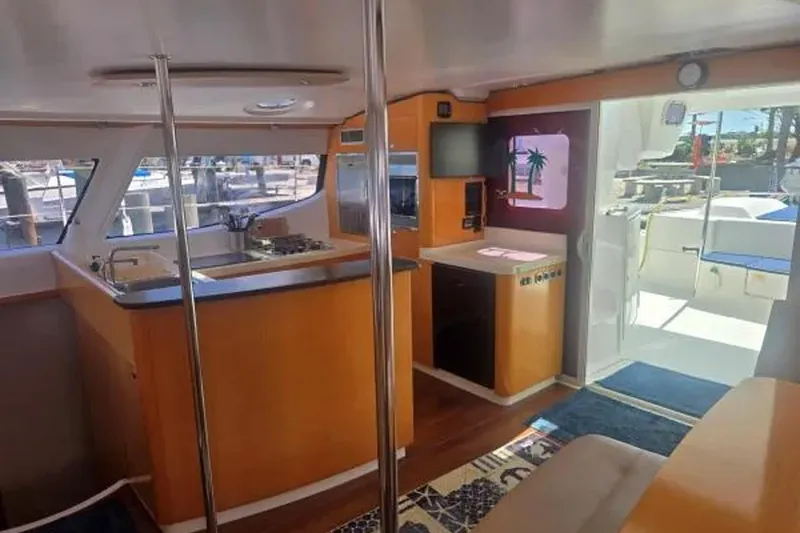 Slide: The Image of Interior of 2008 Fountaine Pajot Salina 48 Evolution catamaran, featuring modern kitchen and seating area. - 18