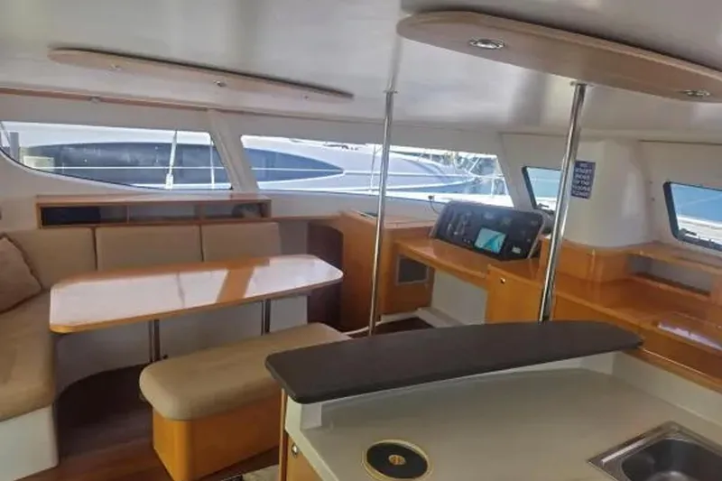 Slide: The Image of Interior of 2008 Fountaine Pajot Salina 48 Evolution catamaran, featuring modern seating and navigation area. - 19
