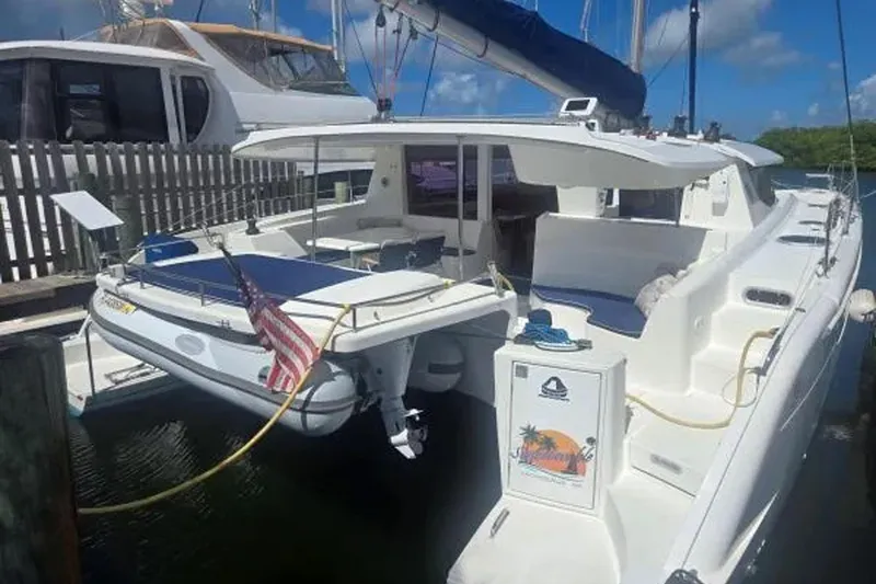 Slide: The Image of 2008 Fountaine Pajot Salina 48 Evolution catamaran docked with American flag. - 2