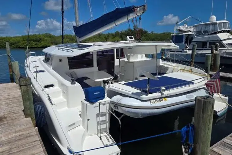 Slide: The Image of 2008 Fountaine Pajot Salina 48 Evolution catamaran docked at marina under blue sky. - 3