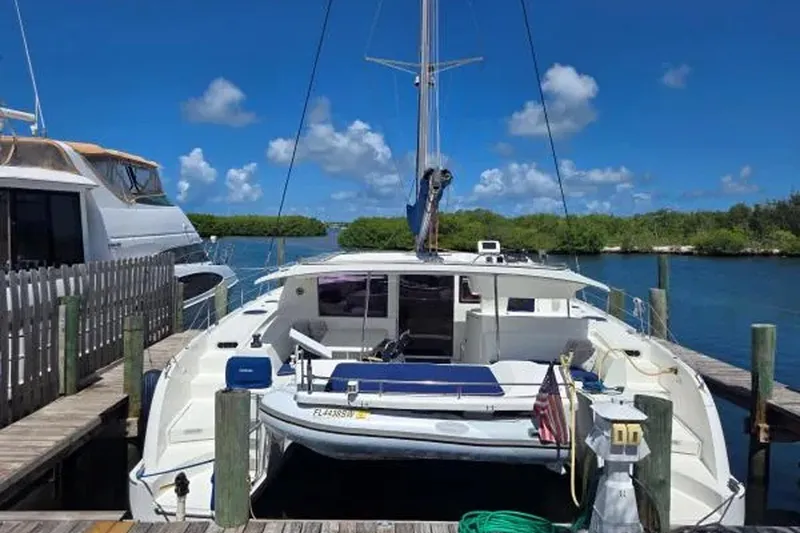 Slide: The Image of 2008 Fountaine Pajot Salina 48 Evolution catamaran docked in a scenic marina. - 4