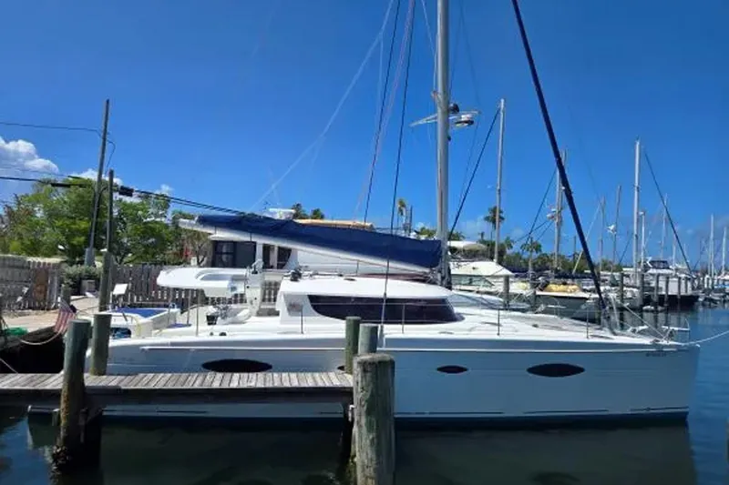Slide: The Image of 2008 Fountaine Pajot Salina 48 Evolution catamaran docked at marina under clear blue sky. - 5