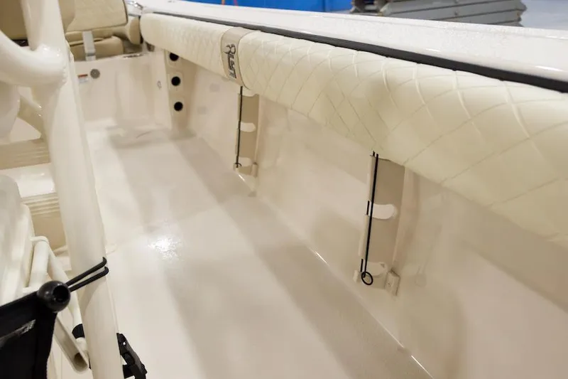 Slide: The Image of Manufacturer Provided Image: 2026 Carolina Skiff 24 Ultra Elite interior with cushioned side panels and rod holders. - 11