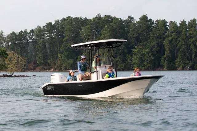 Slide: The Image of Manufacturer Provided Image: 2026 Carolina Skiff 24 Ultra Elite boat cruising on a lake with passengers. - 2