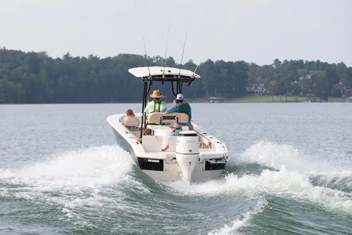 Slide: The Image of Manufacturer Provided Image: 2026 Carolina Skiff 24 Ultra Elite cruising on a lake with passengers, creating a wake. - 3