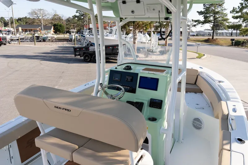 Slide: The Image of 2026 Sea Pro 225FLXR Sandbar boat interior with helm, seating, and modern controls. - 10
