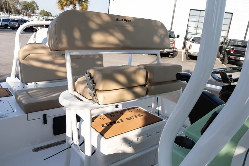 Slide: The Image of 2026 Sea Pro 225FLXR Sandbar boat interior with tan seating and storage. - 16