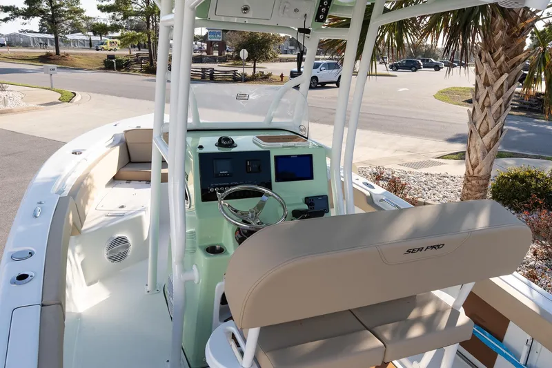 Slide: The Image of 2026 Sea Pro 225FLXR Sandbar boat interior with helm, seating, and modern controls. - 9
