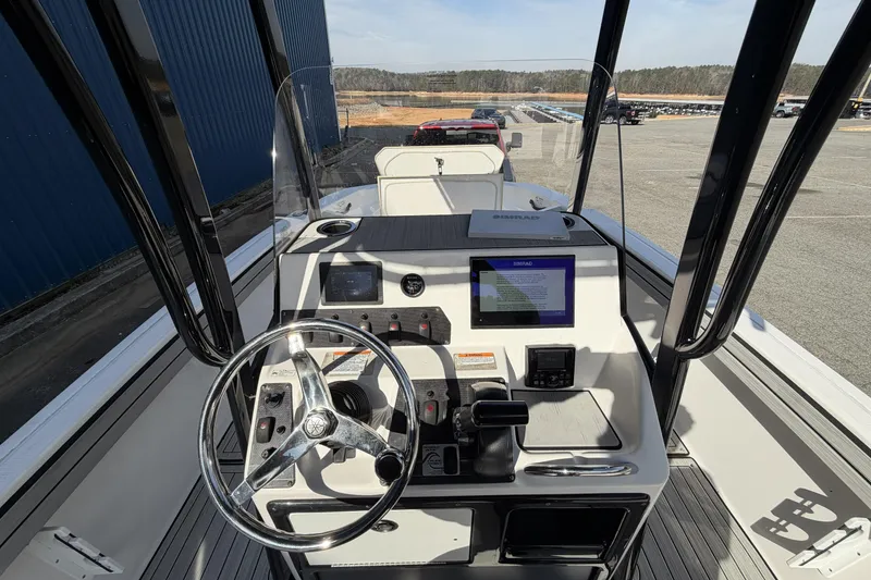 Slide: The Image of 2021 Yamaha Boats 195 FSH Sport dashboard with steering wheel and navigation display. - 10