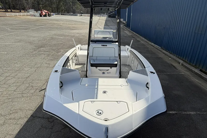 Slide: The Image of 2021 Yamaha Boats 195 FSH Sport in a parking lot, showcasing its sleek design. - 8