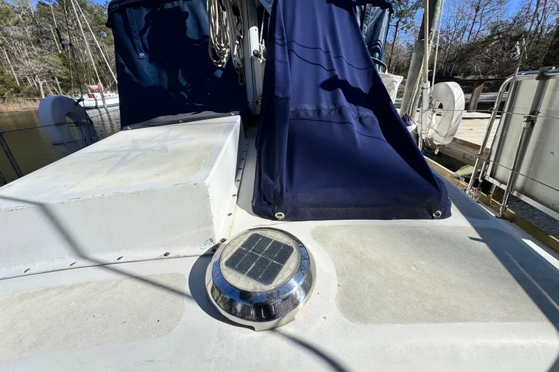 Slide: The Image of 1980 Dickerson Center Cockpit Ketch deck with solar light and blue canvas cover. - 16