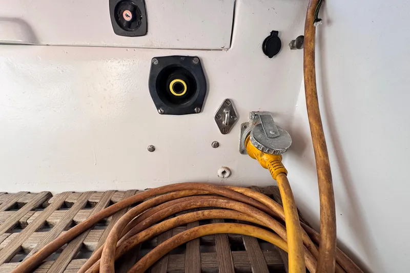 Slide: The Image of Electrical connections on a 1980 Dickerson Center Cockpit Ketch with coiled yellow cable. - 24