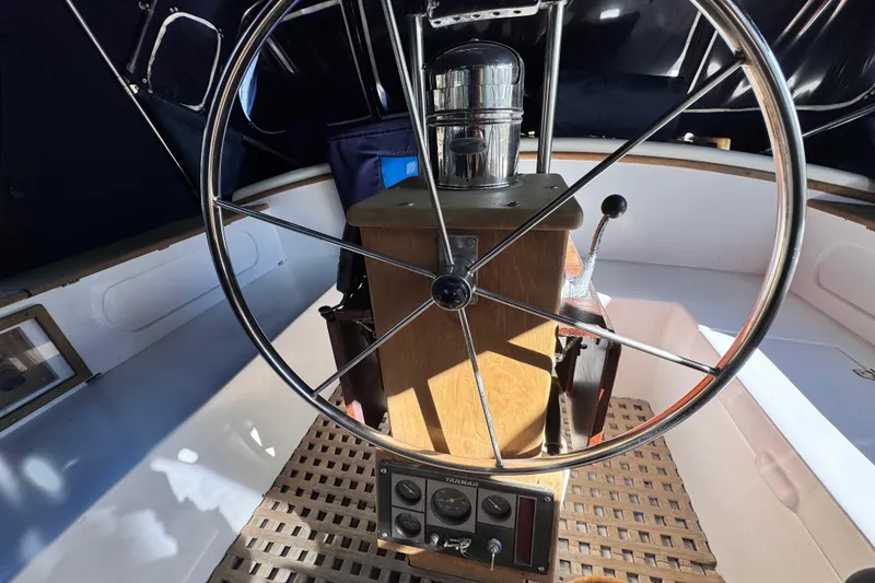 Slide: The Image of Steering wheel of a 1980 Dickerson Center Cockpit Ketch sailboat, featuring classic nautical design. - 27