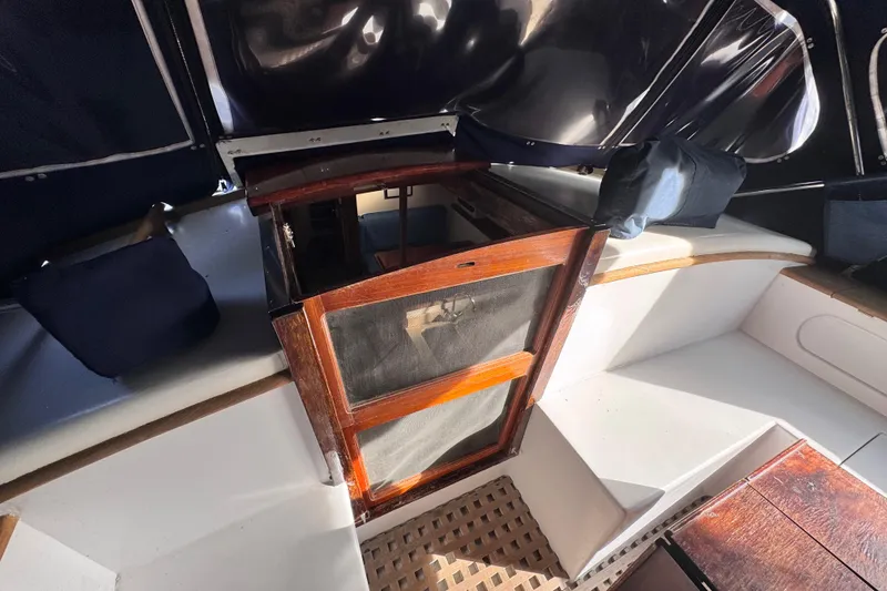 Slide: The Image of 1980 Dickerson Center Cockpit Ketch interior with wooden hatch and seating area. - 31