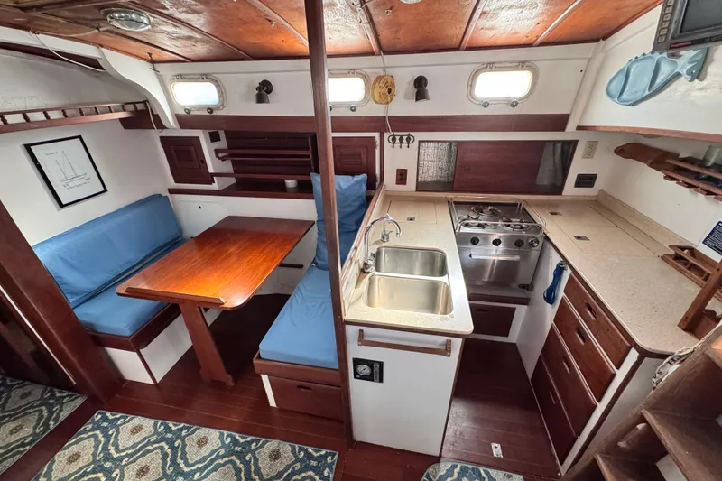 Slide: The Image of Interior of a 1980 Dickerson Center Cockpit Ketch with kitchen and dining area. - 36