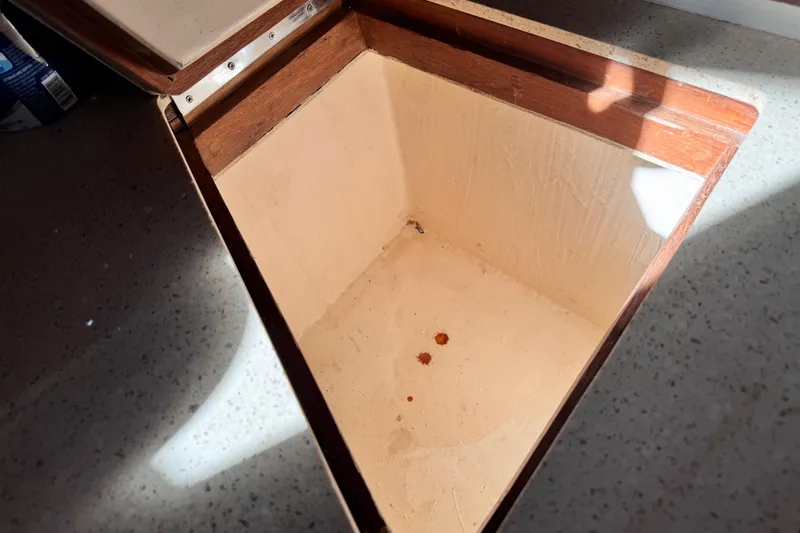 Slide: The Image of Open wooden storage compartment on 1980 Dickerson Center Cockpit Ketch boat. - 43