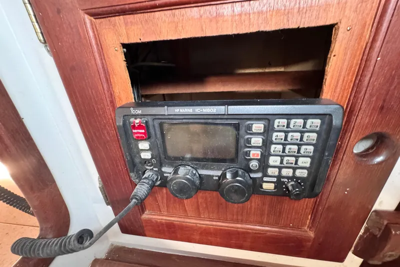 Slide: The Image of Vintage marine radio on 1980 Dickerson Center Cockpit Ketch, wooden panel background. - 50