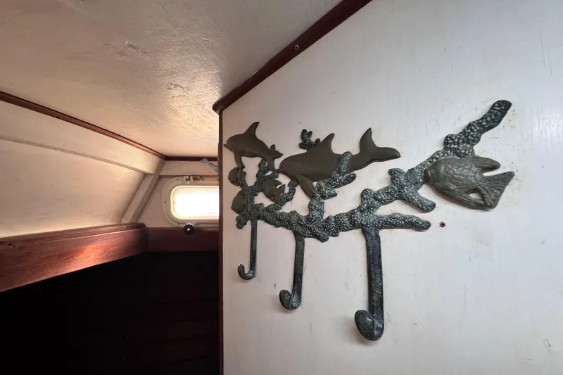 Slide: The Image of Interior of 1980 Dickerson Center Cockpit Ketch with nautical-themed wall hooks. - 61