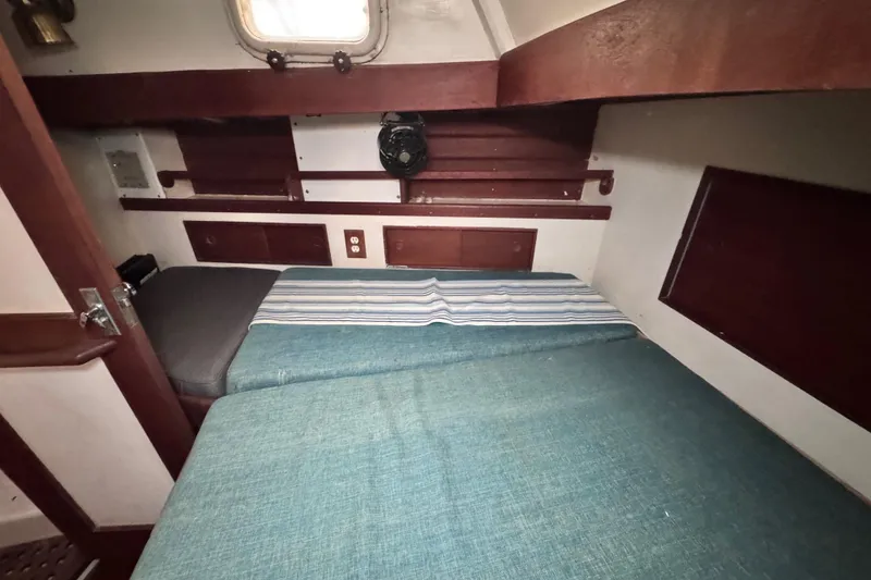 Slide: The Image of Cozy cabin interior of 1980 Dickerson Center Cockpit Ketch with twin beds and wooden accents. - 83