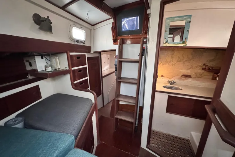 Slide: The Image of view from the bed of the aft cabin, to the right is the private head , middle is the companionway to the cockpit and the left is the hallway leading to the galley / salon area - 86