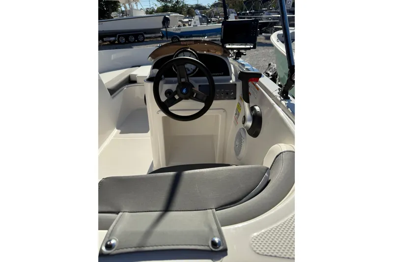 Slide: The Image of 2025 Bayliner Element E18 boat interior with steering wheel and seating. - 11