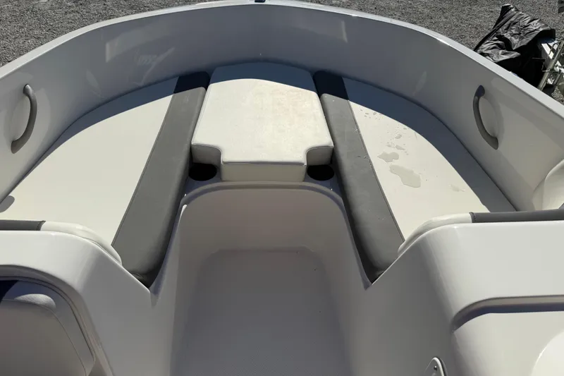 Slide: The Image of 2025 Bayliner Element E18 boat interior with cushioned seating and cup holders. - 13