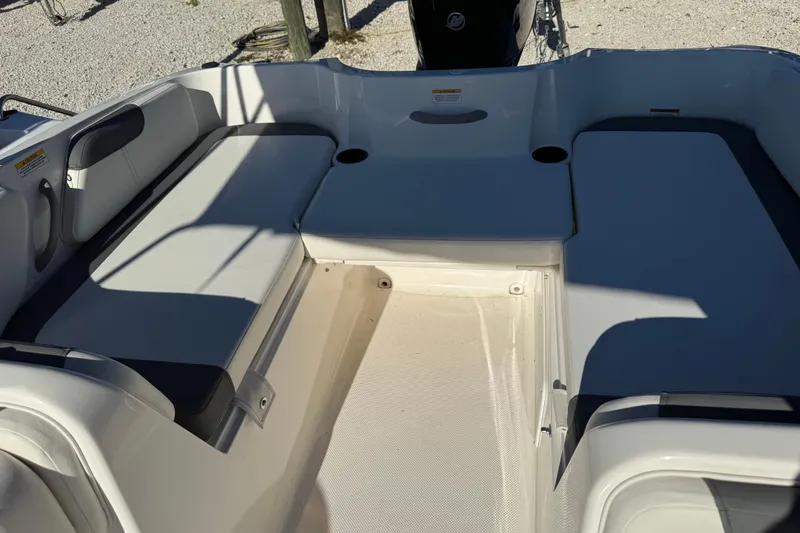 Slide: The Image of 2025 Bayliner Element E18 boat interior with cushioned seating and cup holders. - 14
