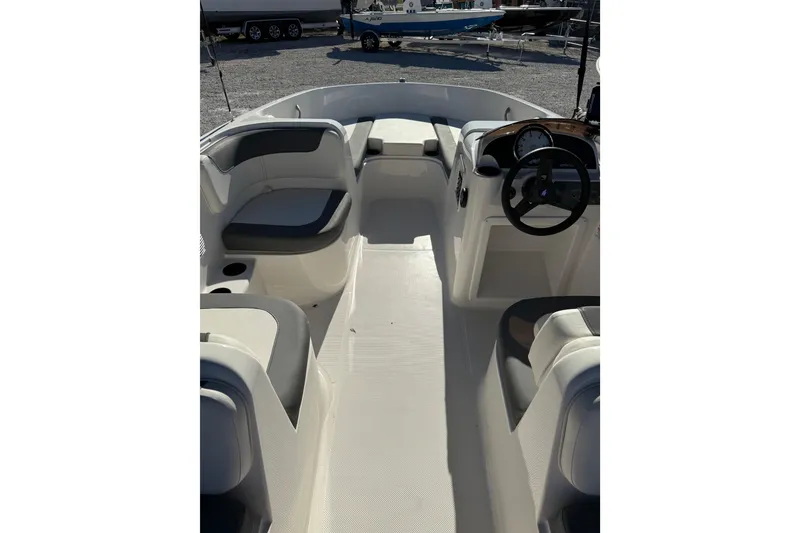 Slide: The Image of 2025 Bayliner Element E18 boat interior with seating and steering wheel. - 15